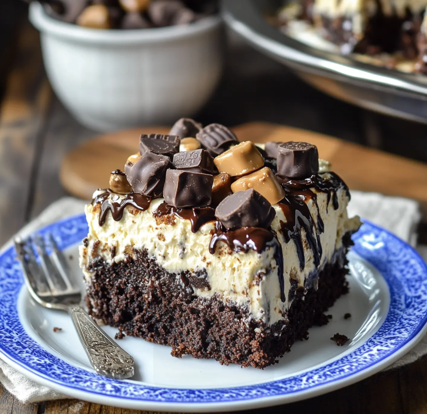A slice of chocolate cake with chocolate chips and caramel drizzle.