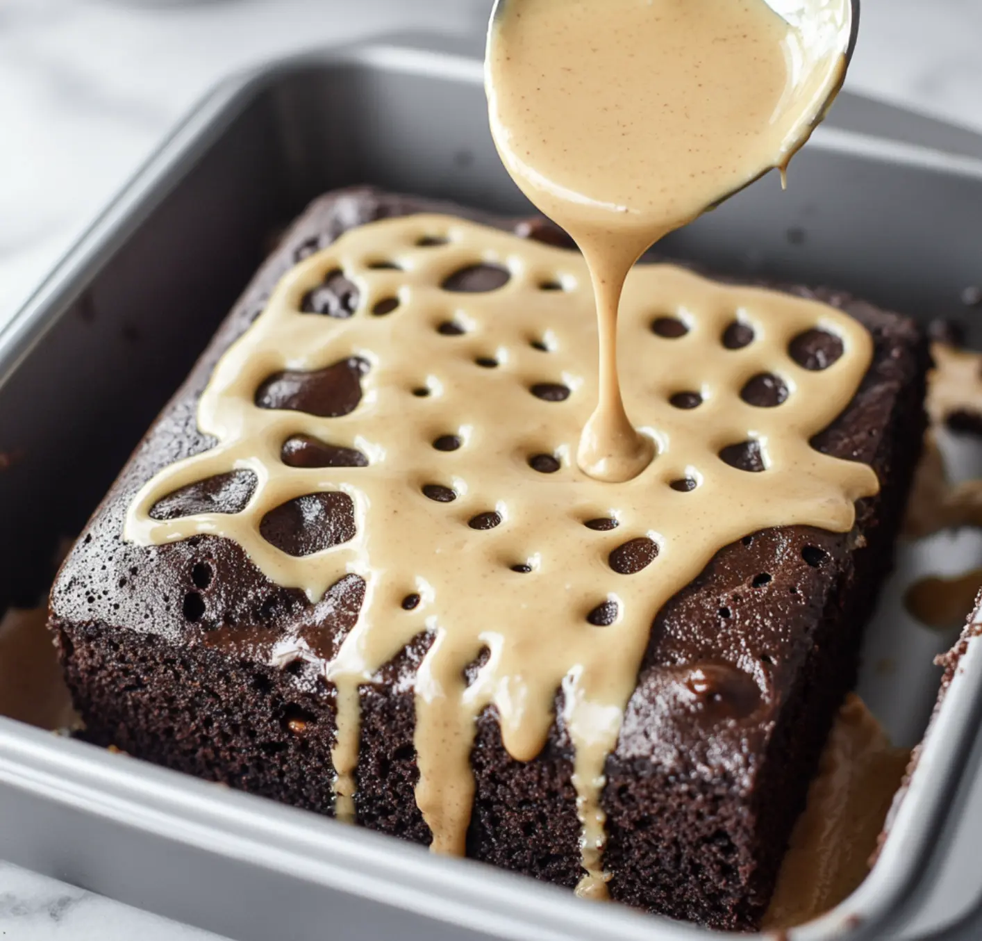 A chocolate cake with caramel drizzled on top.