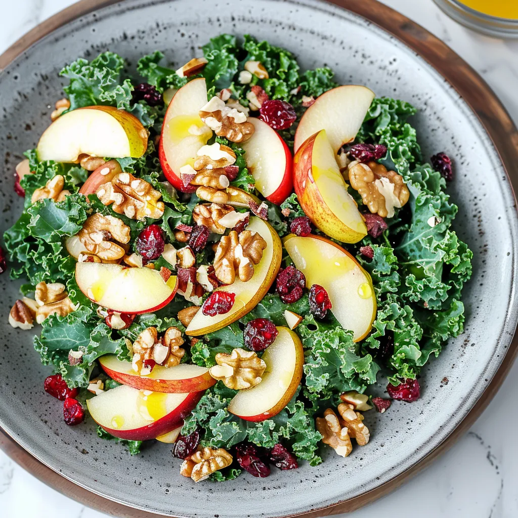 A bowl of salad with apples, walnuts, and kale.